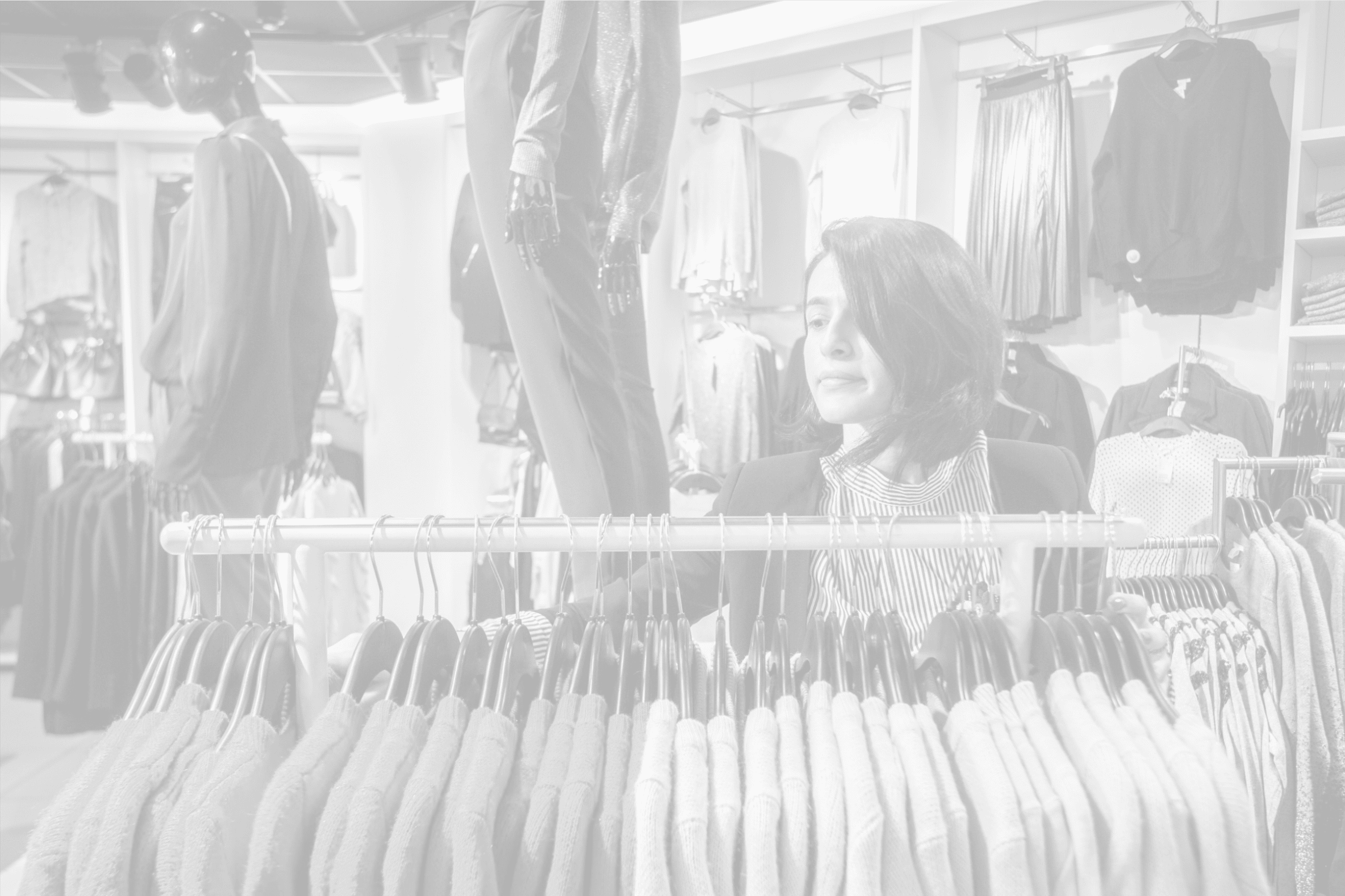 young woman sorting out clothes on a rail