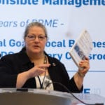 Carole Parkes mid-presentation at a podium