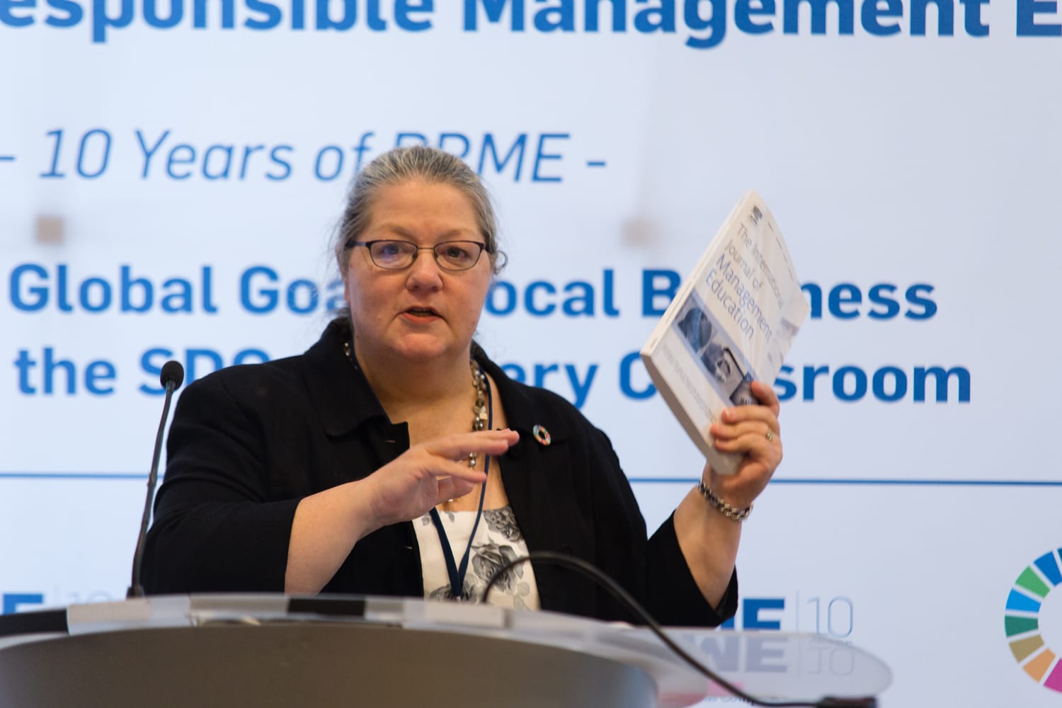 Carole Parkes mid-presentation at a podium