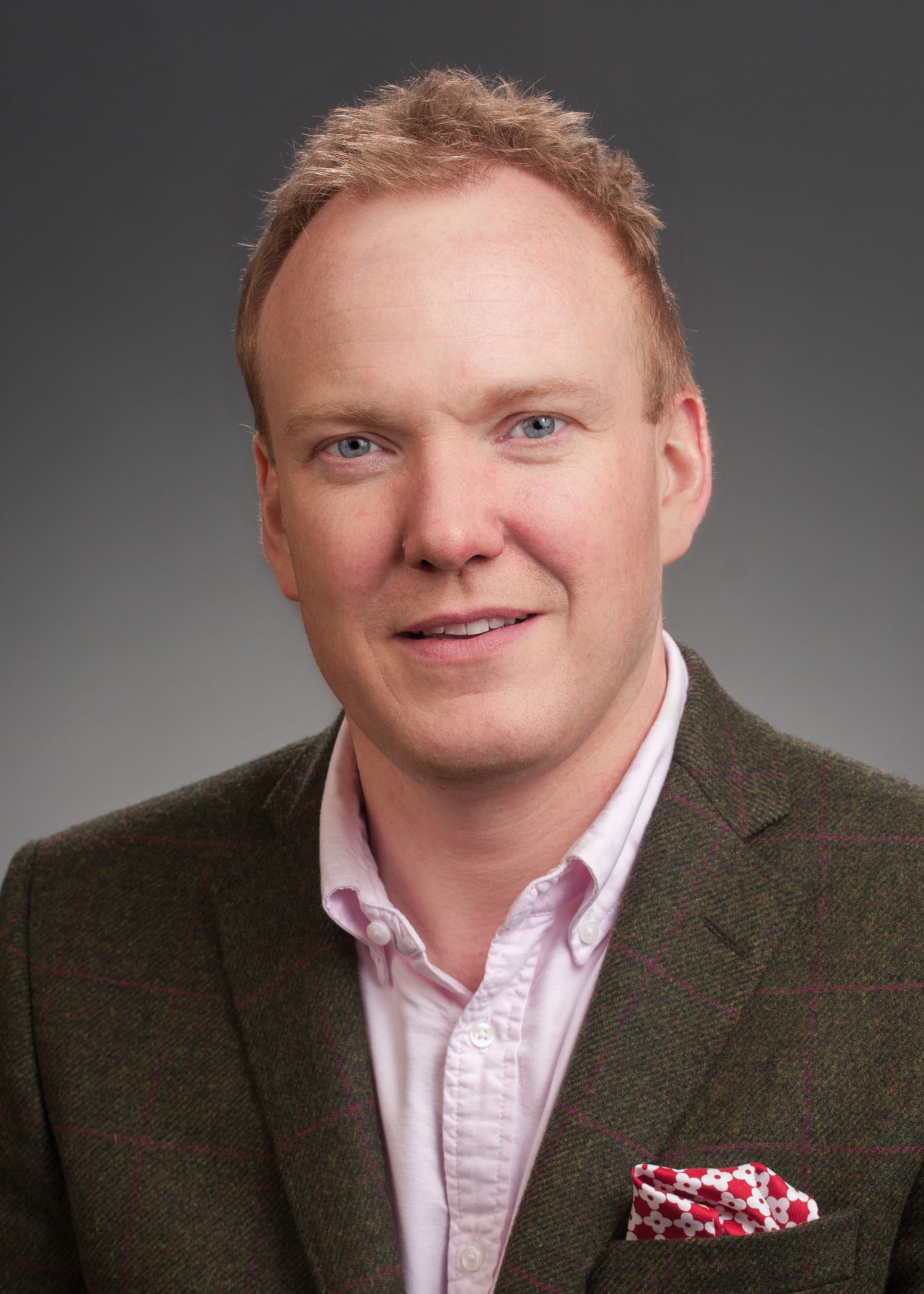 Chris Gray in a dark tweed jacket with a brightly coloured pocket square