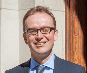 Jeremey Pocklington smiles outside a building